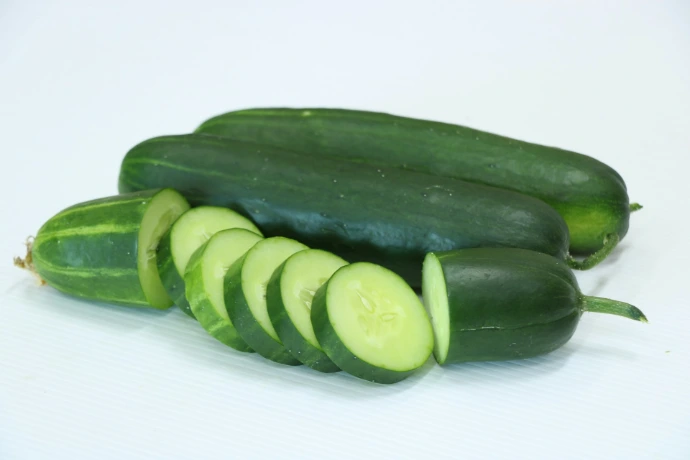A group of cucumbers on a white surface